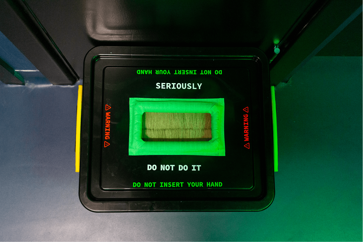 An interactive sensory box lid warning visitors not to insert their hand